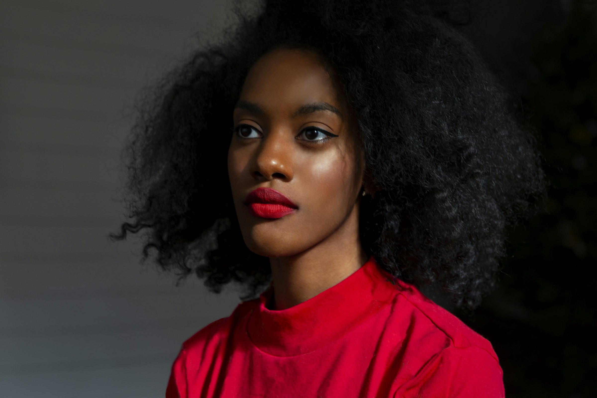 Woman with voluminous natural hair in a red top