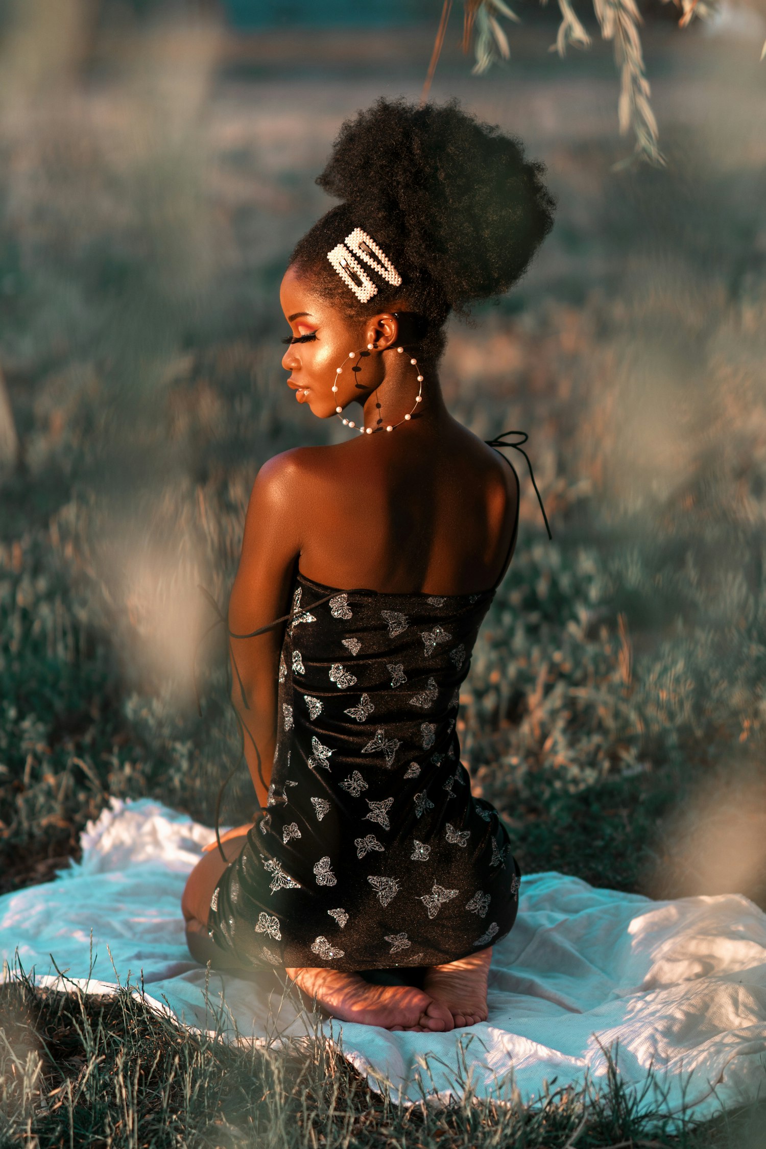 Woman with a braided updo sitting outdoors