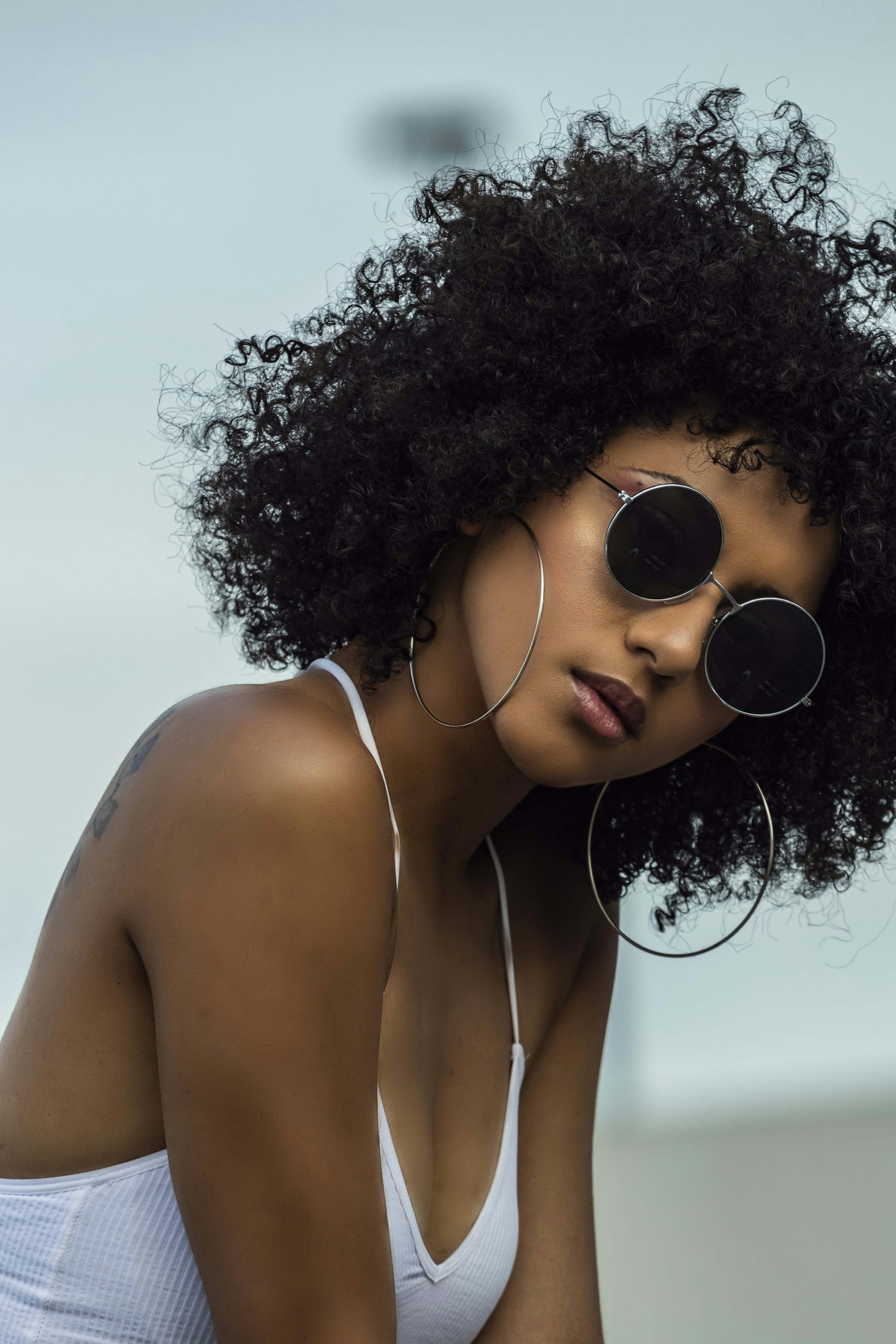 Woman with natural curls and sunglasses
